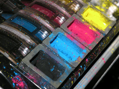 Close up image of toner cartridges - black, cyan, magenta and yellow