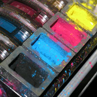 Open toner cartridges showing black, cyan, magenta and yellow powder