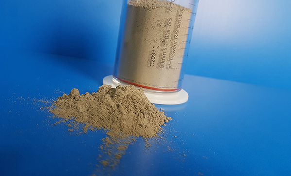 Optimising the flow properties of cement powders by surface treatment